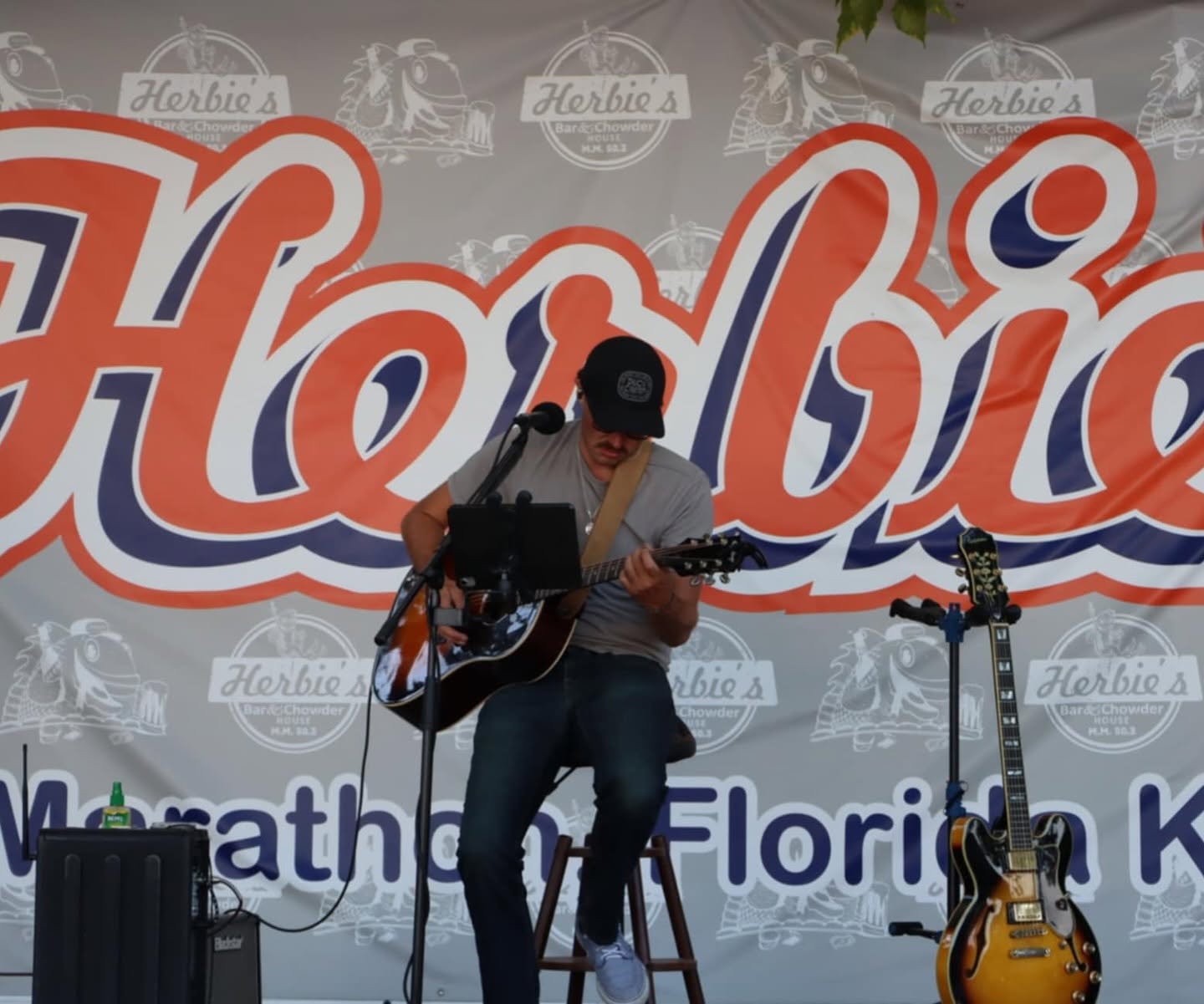 Pierce August performing on stage at Herbie's Bar & Chowder House in Marathon, FL