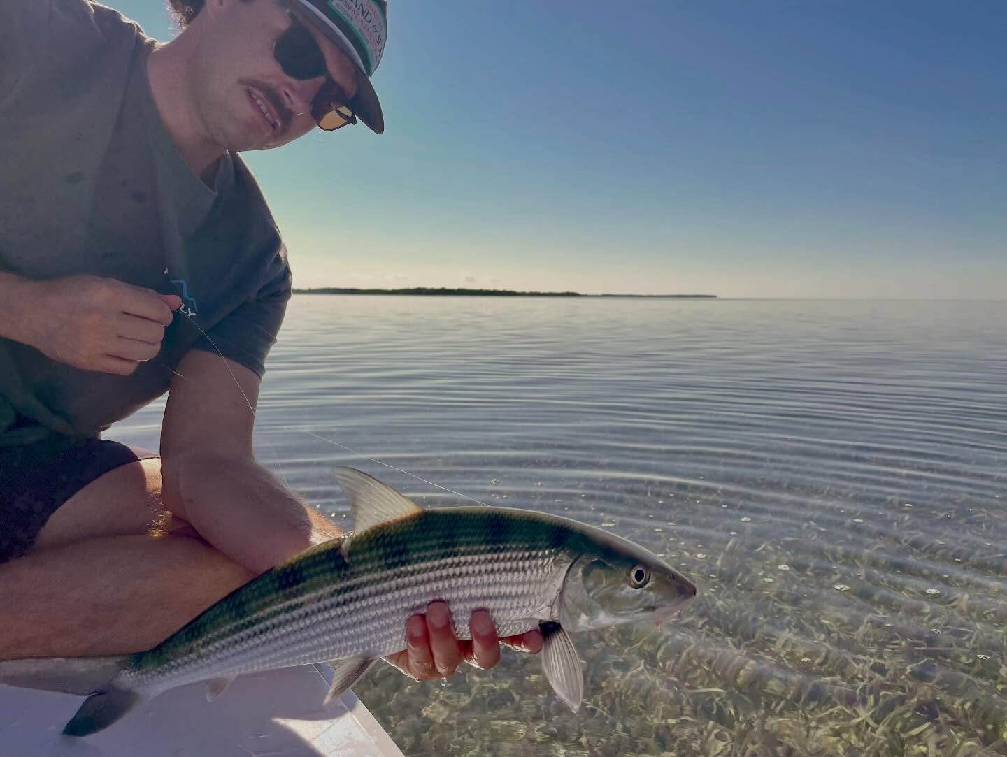 Pierce August holding a bonefish on the flats